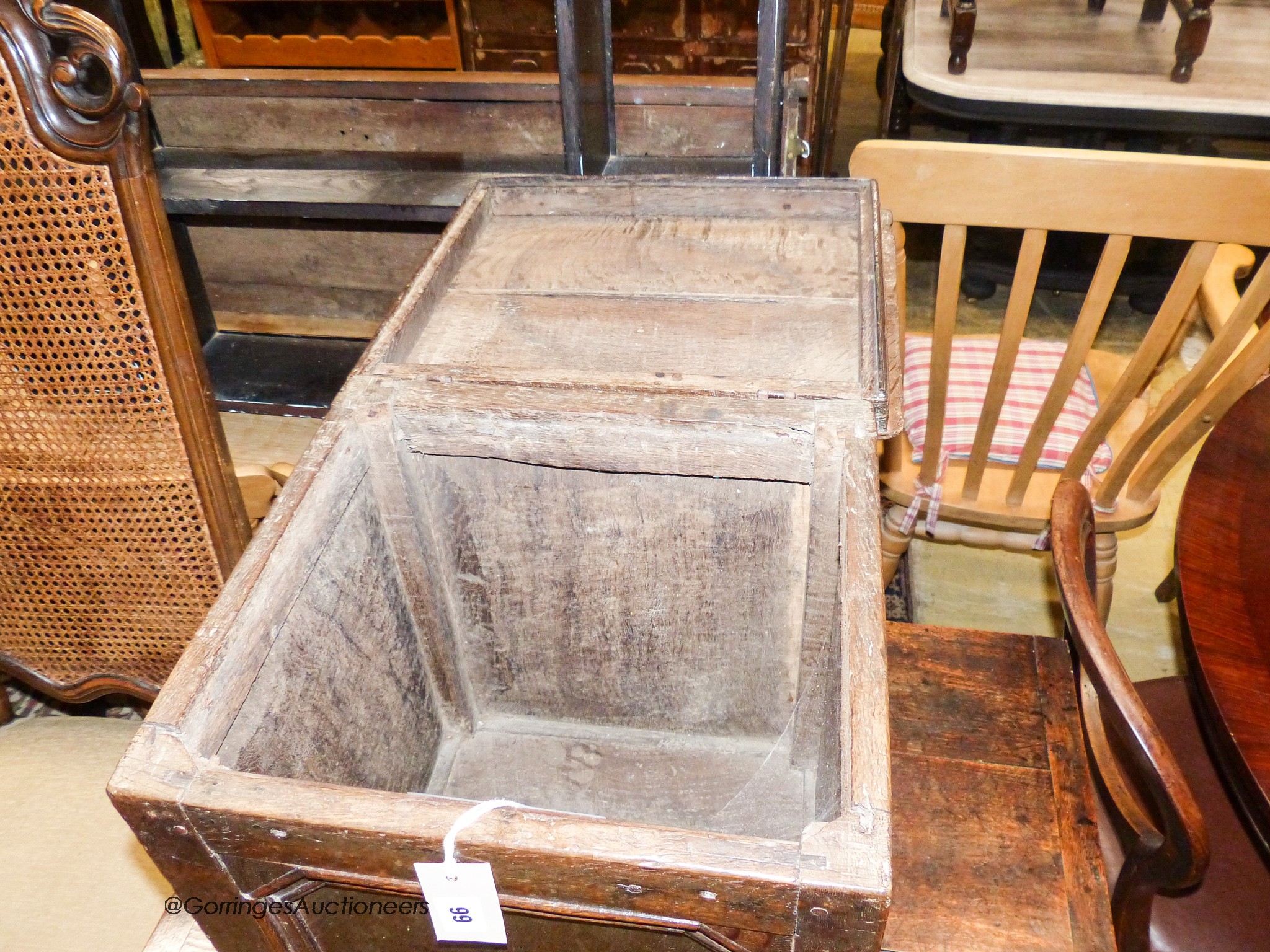 An 18th century oak cupboard of small proportions with rectangular hinged lid, width 43cm, depth 37cm, height 49cm